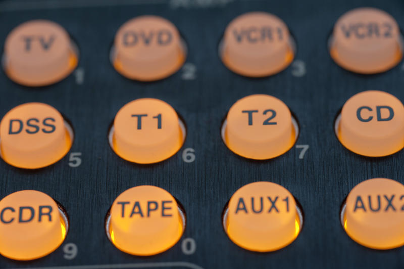 Yellow audio source control buttons with illumination, close-up full frame image