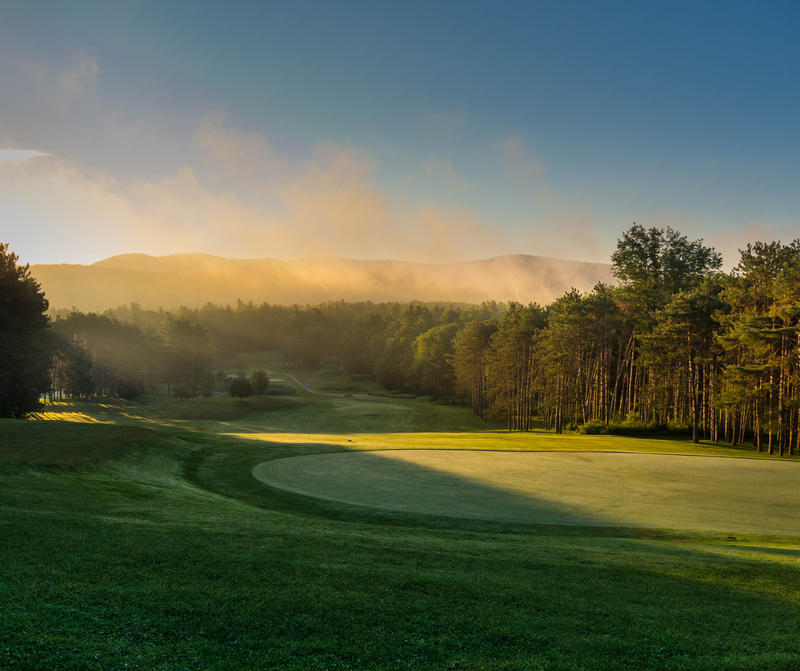 <p>Golf course in the morning with mist clearing.</p>
