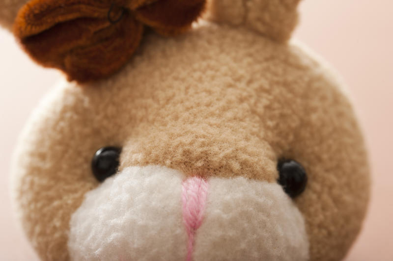 Cute little face of a soft fluffy toy Easter bunny staring at the viewer in a close up cropped view