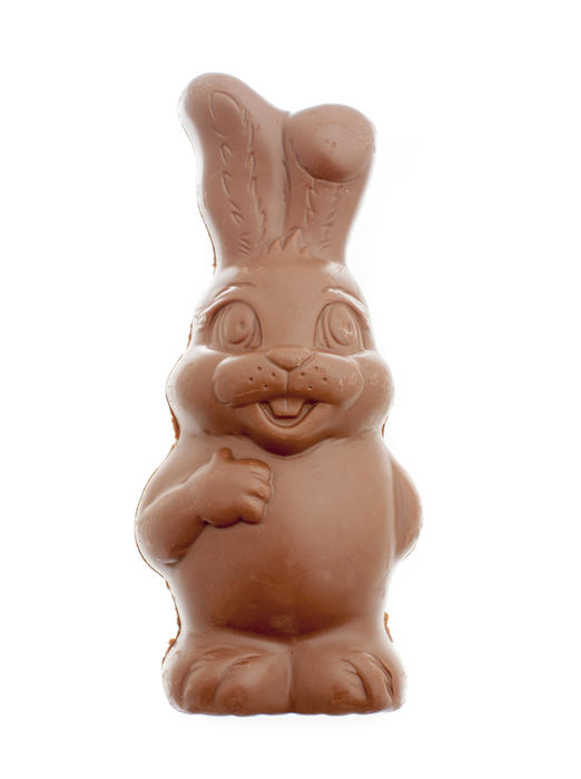 Figure of chocolate Easter Bunny unwrapped standing isolated on white background