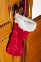 13149   Colorful red Christmas stocking hanging on a door