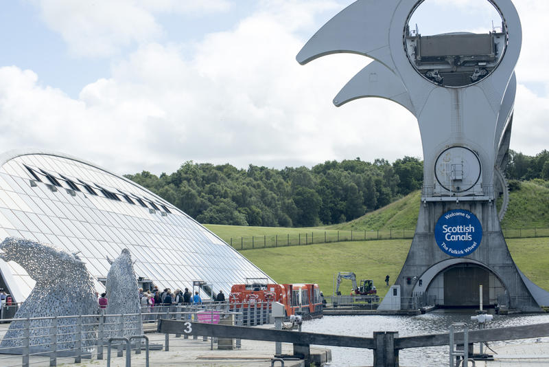 Front view from edge of pier of raised boat lift portion of the Falkirk Wheel in Scotland