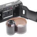 12166   Single roll of film next to compact camera