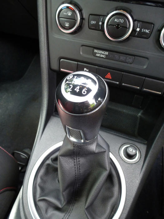 Manual gear shift lever in a modern car mounted on the center console in a close up high angle view