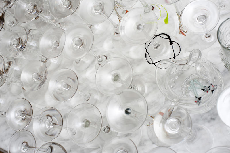 Upturned assorted clean stemmed glassware on a white surface viewed from above in a bar or restaurant