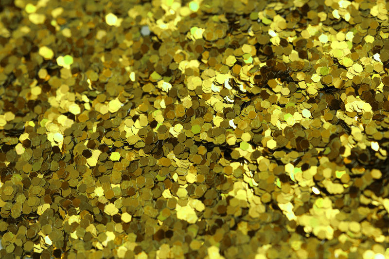 a background texture of gold coloured glitter flecks
