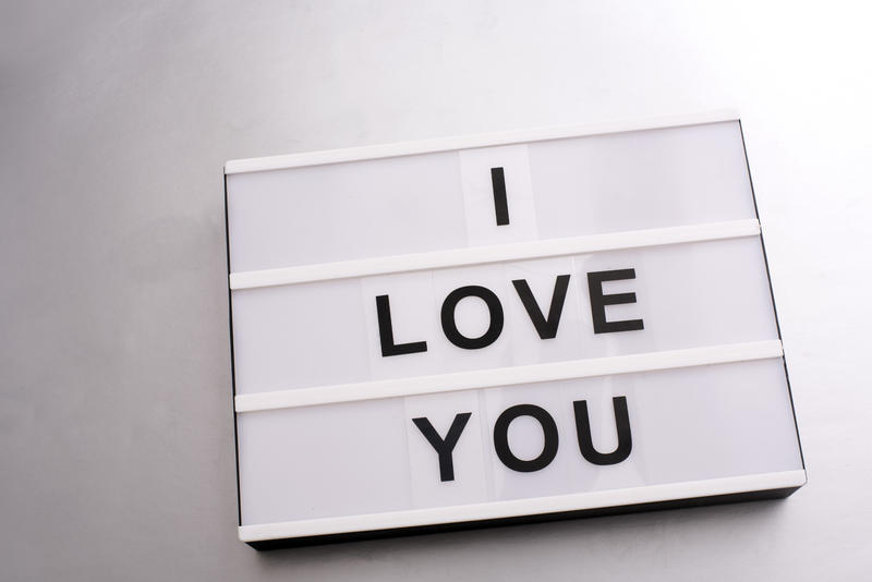 Changeable sign with I LOVE YOU letters on white background. Close-up over white surface