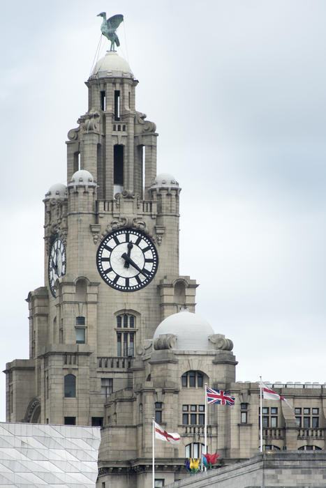 Tall clock tower and domes on the Liver Building in the United Kingdom city of Liverpool