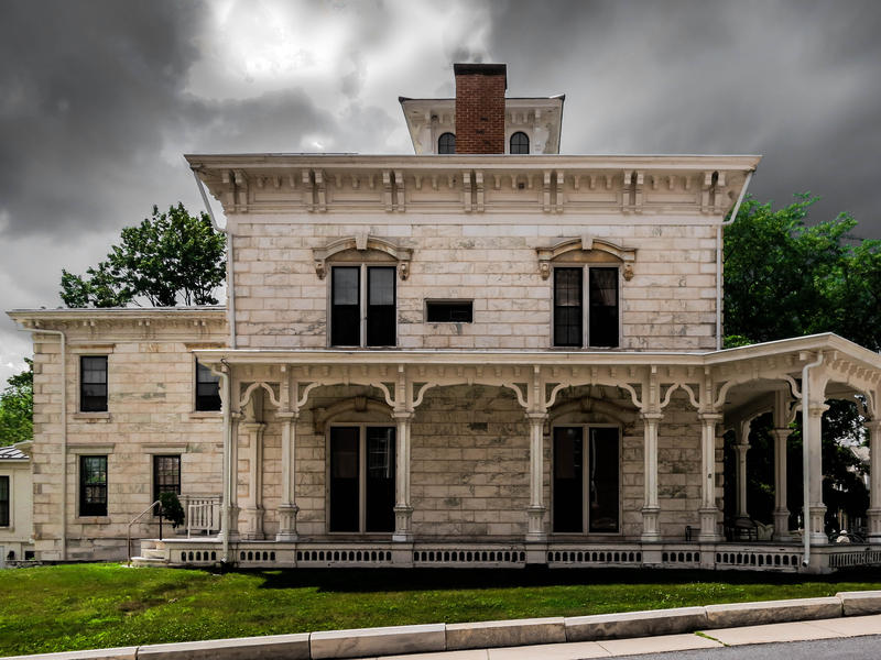 <p>Old marble hotel after the rains in rural Vermont with grey clouds and green grass. Haunted even in the daytime...</p>
