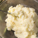 13019   Buttered mashed potatoes in glass bowl with spoon