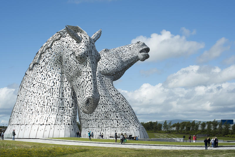Scenic view of tourists sightseeing at the Kelpies, Falkirk, a sculpture of two horse heads commemorating their role in Scottish industry