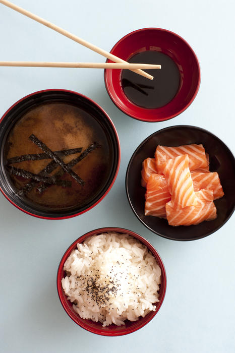 bows of japanese food, soy sauce, salmon and rice with miso soup