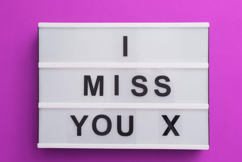 I Miss You Valentines message in bold black lettering on a lightbox with an X for a kiss in a sentimental message for a sweetheart or loved one