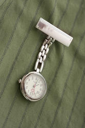 12952   Stainless steel nurses watch pinned to a uniform