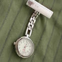 12952   Stainless steel nurses watch pinned to a uniform