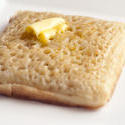 12272   Buttered wheat crumpet on plate