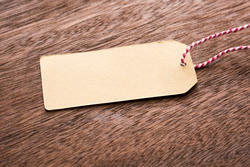 13130   Blank brown gift tag or label on wood