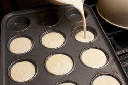 13025   Cake batter being poured into muffin tin