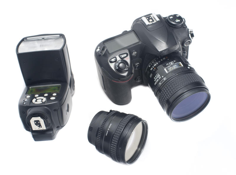 Isolated digital camera, wide angle lens and adjustable flash strobe over white background