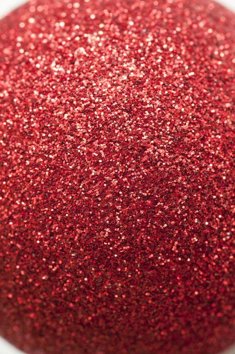 Extreme close up view on red glitter ornament ball