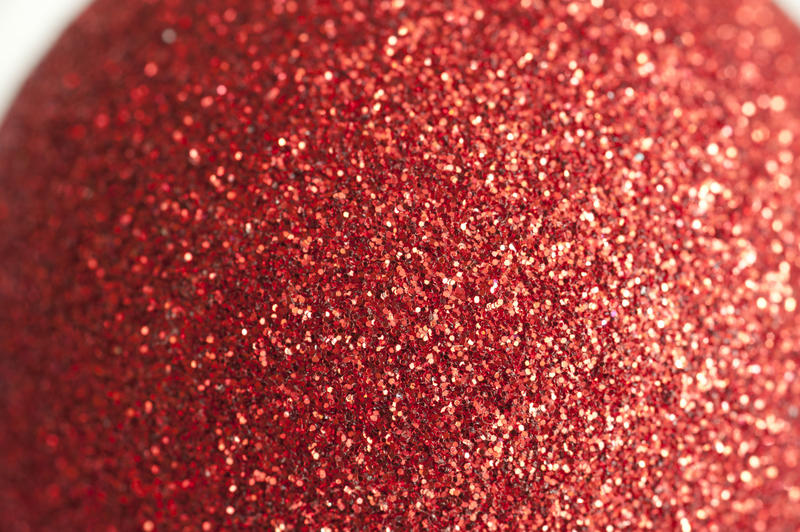 a close up image of a sparkly red glitter covered ball