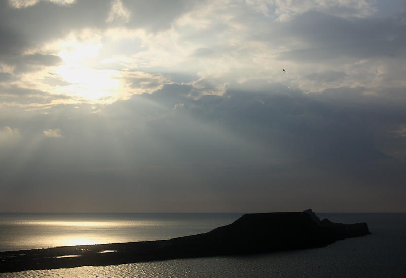 <p>A moody view of the Worms Head in Rhossili on the Gower Peninsula. A rocky outcrop on the southernmost tip of South Wales.</p>
