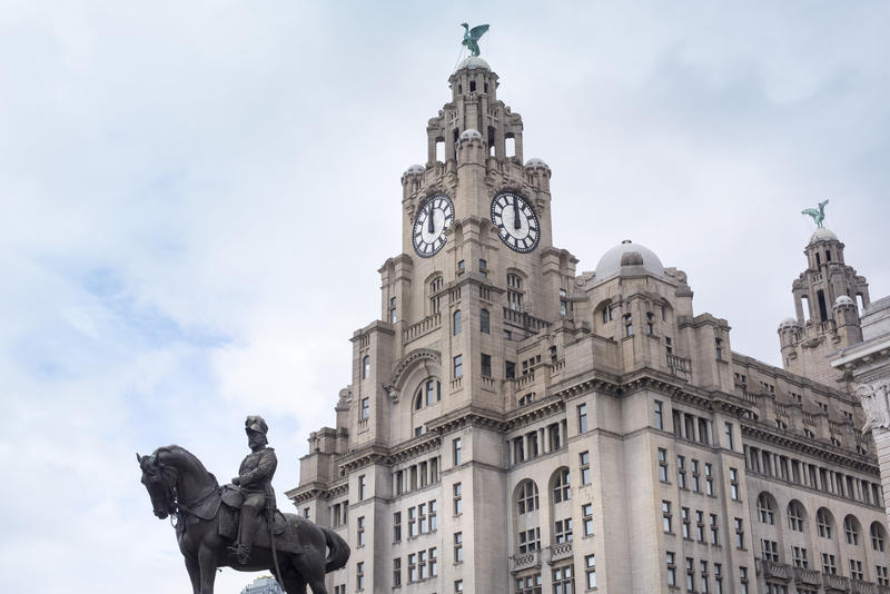 Clock tower of Liver Building overlooking statue of Edward VII mounted on a horse outdoors
