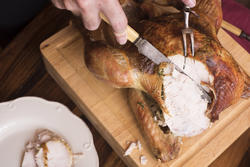 17175   Man slicing a roasted Christmas turkey