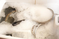 17163   Dirty dishes in soapy water in a sink