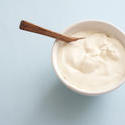 13030   Small white round bowl of plain yogurt with spoon