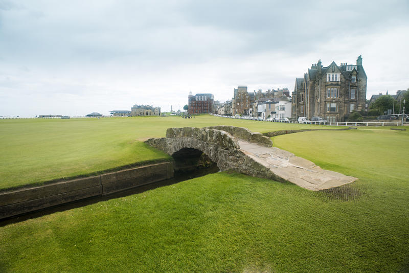 Little bridge over small canal at the empty green grass field of Saint Andrews Golf Course