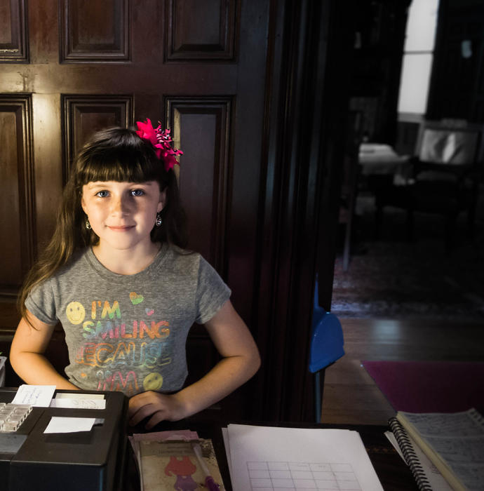 <p>Young girl at her clerk desk welcoming her guests with a smile. editorial use: supplied without model release</p>

