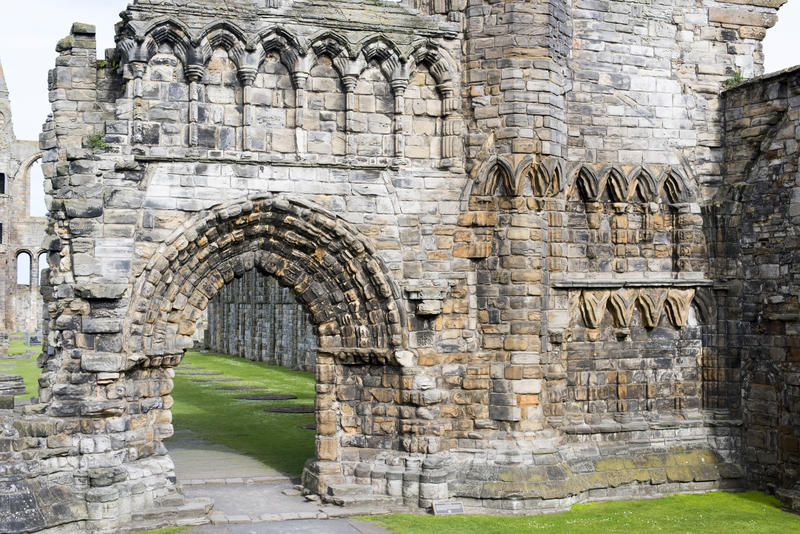 Ancient Gothic arch and the remnants of an old medieval stone wall , St Andrews Cathedral ruins, St Andrews, Scotland
