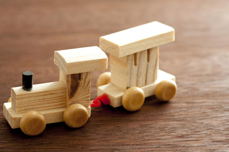 Still Life of Wooden Train with Caboose Car, Simple Toy for Child on Wooden Background with Copy Space