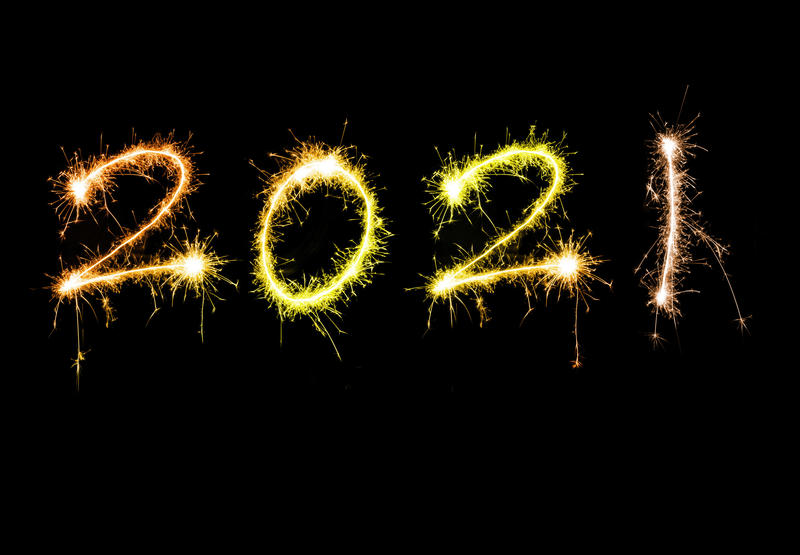 New years 2021 sparkling sign with golden orange digits floating isolated against black background