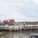 17828   Red cement mixer truck park on a wharf or quay