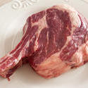 17256   Close up of raw rib eye steak on white plate