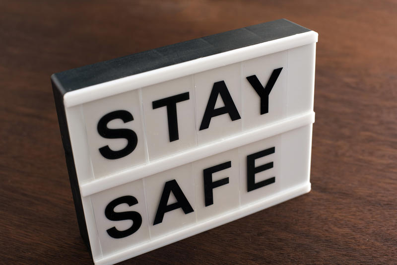 Small Stay Safe sign on a table or floor urging people to take care during the Covid-19 pandemic